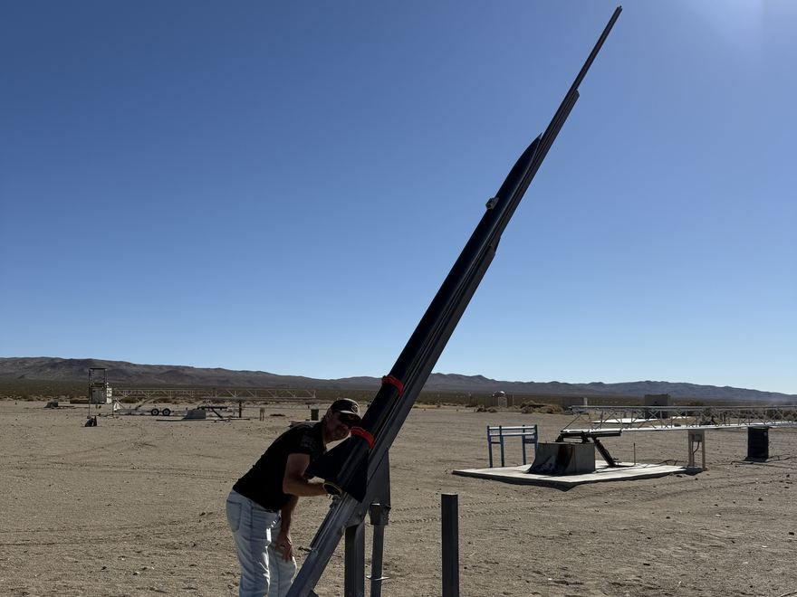 The launch tower being raised at FAR with ION 4.2 loaded on it, range pads and the Mojave hills behind
