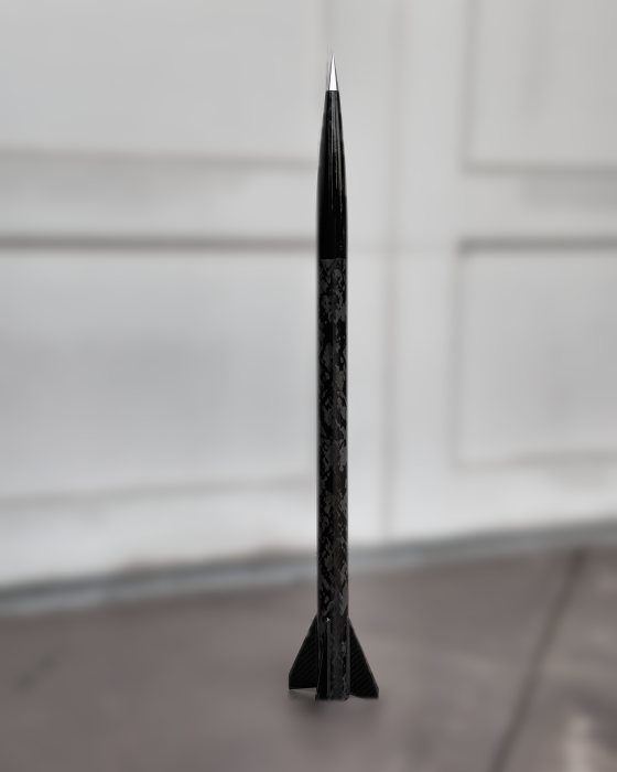 ION 38.1 standing on the driveway against a defocused garage door — two and a half feet of 38 mm carbon