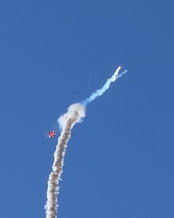 ION 4.2 breaking up in flight, the smoke trail bending as debris falls away