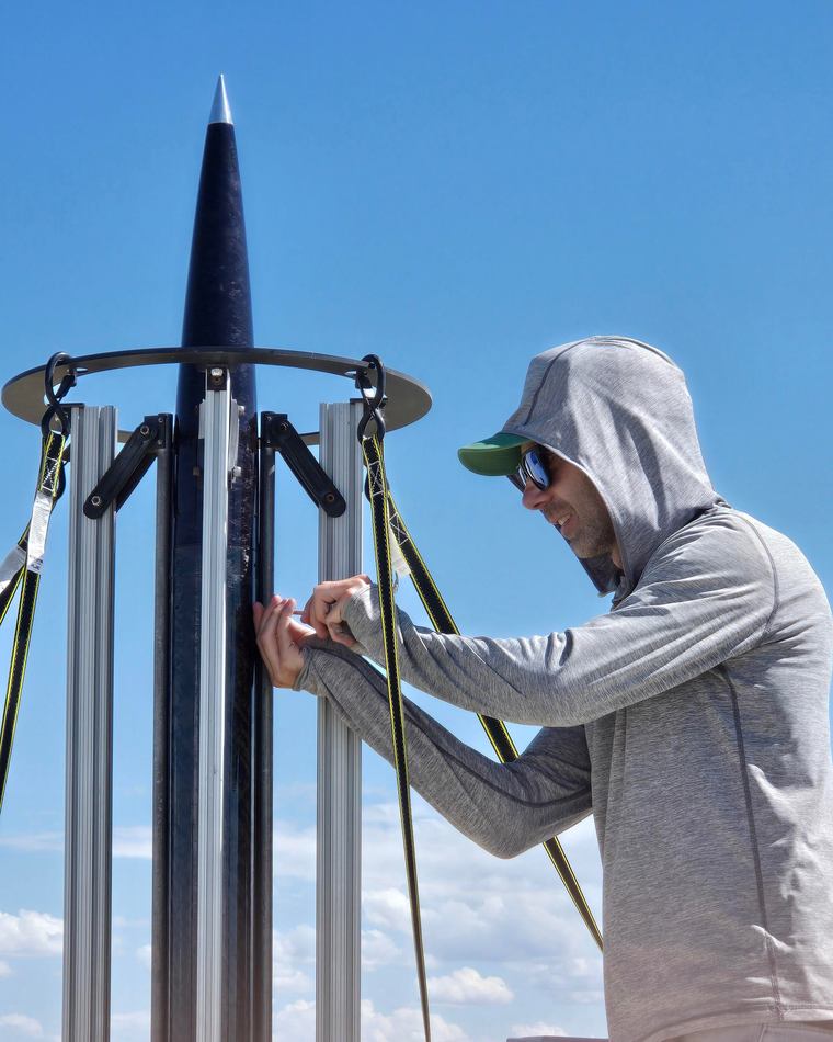 Final prep on ION 4.3 in the tower at XPRS, the carbon nose cone and its aluminium tip standing above the rail extrusions